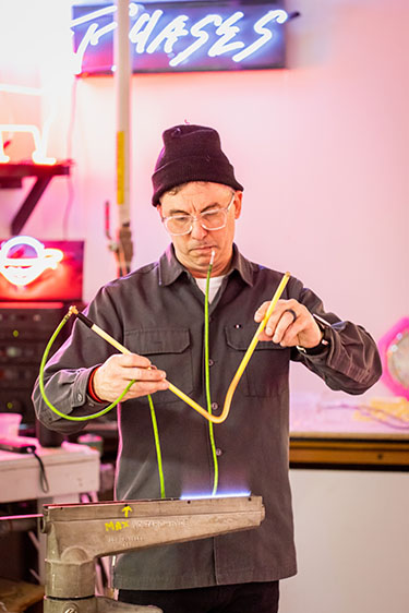 Tom Zickuhr bending neon over a flame